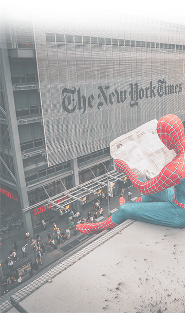 Spiderman reading a newspaper in front of The New York Times
